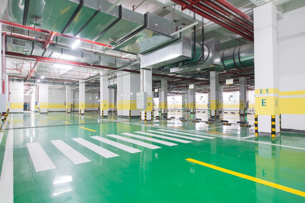 interior of parking garage with car and vacant parking lot in parking building